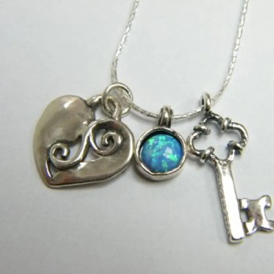 Sterling Silver wearable art charms necklace with a heart and a key to the heart pendant.