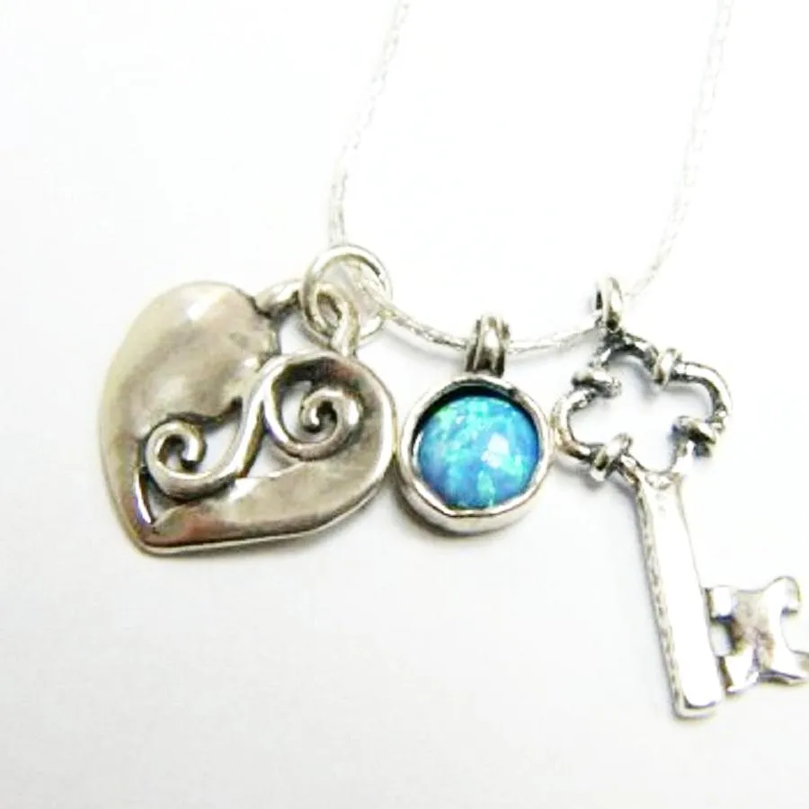 Sterling Silver wearable art charms necklace with a heart and a key to the heart pendant.